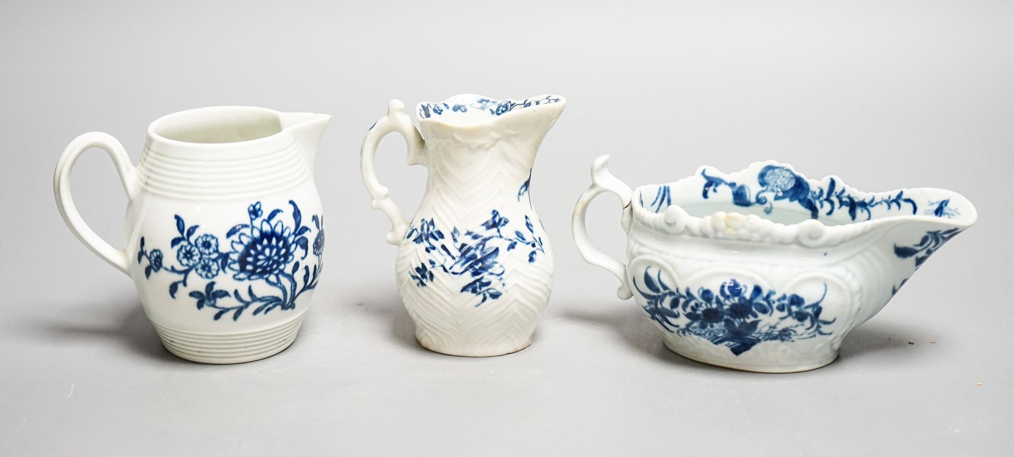 A Worcester blue and white sauceboat, sparrow beak milk jug and a Mansfield pattern milk jug, tallest 9 cm